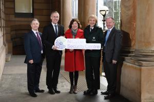 Speakers at the launch event holding NI Cyber Security Centre logo